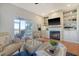 Living area with fireplace, built-ins, hardwood floors and sliding glass doors to deck at 8934 Sandy Creek Rd, Edisto Island, SC 29438