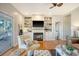 Living room with fireplace, built-in shelving, hardwood floors, and access to deck at 8934 Sandy Creek Rd, Edisto Island, SC 29438