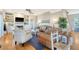 Cozy living room with a fireplace and built-in shelving, leather couches, and hardwood floors at 8934 Sandy Creek Rd, Edisto Island, SC 29438