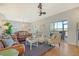 Open living room showcasing leather sofas, hardwood floors, and views of marsh at 8934 Sandy Creek Rd, Edisto Island, SC 29438