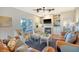 Spacious living room with fireplace, built-in shelving, hardwood floors, and access to deck at 8934 Sandy Creek Rd, Edisto Island, SC 29438
