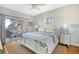 Main bedroom with king bed, private deck access, and hardwood floors at 8934 Sandy Creek Rd, Edisto Island, SC 29438