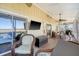 Relaxing screened porch with wicker furniture, TV, and marsh views at 8934 Sandy Creek Rd, Edisto Island, SC 29438