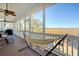Serene screened porch with a hammock and marsh views at 8934 Sandy Creek Rd, Edisto Island, SC 29438