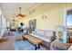 Spacious screened porch with comfy seating and a wooden coffee table at 8934 Sandy Creek Rd, Edisto Island, SC 29438