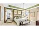 Main bedroom with green and beige decor, a king-size bed, and an ensuite bathroom at 102 Black Stilt Way, Summerville, SC 29483