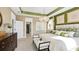 Main bedroom with green and beige decor, a king-size bed, and an ensuite bathroom at 102 Black Stilt Way, Summerville, SC 29483