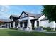 Charming exterior of the community building with outdoor seating, complemented by well-manicured landscaping at 102 Black Stilt Way, Summerville, SC 29483