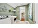 Bright laundry room with washer, dryer, and ample storage at 102 Black Stilt Way, Summerville, SC 29483