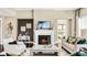 Spacious living room with a cozy fireplace and ample natural light at 102 Black Stilt Way, Summerville, SC 29483
