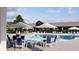 Relaxing pool area with tables, chairs, and umbrellas at 102 Black Stilt Way, Summerville, SC 29483