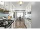 Bright kitchen with white cabinets, stainless steel appliances and wood floors at 109 Salem Ct, Summerville, SC 29486