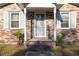 Front door entrance with storm door and brick surround at 1134 S Shadow Dr, Mount Pleasant, SC 29464