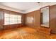 Living room boasts wood paneling, built-in storage, and orange carpet at 1134 S Shadow Dr, Mount Pleasant, SC 29464