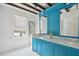 Bathroom with teal vanity, double sinks and marble countertop at 124 Mary St, Mount Pleasant, SC 29464