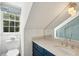 Modern bathroom with a blue vanity, white subway tiles, and a glass shower at 124 Mary St, Mount Pleasant, SC 29464