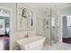Spa-like bathroom featuring a freestanding tub and a glass shower at 124 Mary St, Mount Pleasant, SC 29464