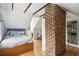 Serene bedroom with exposed brick, wood floors, and built-in storage at 124 Mary St, Mount Pleasant, SC 29464