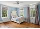 Bright bedroom with a white wooden bed and French doors at 124 Mary St, Mount Pleasant, SC 29464