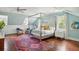 Serene bedroom with canopy bed, built-in storage, and hardwood floors at 124 Mary St, Mount Pleasant, SC 29464