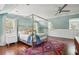 Bright bedroom with canopy bed, built-in storage, and hardwood floors at 124 Mary St, Mount Pleasant, SC 29464