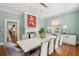Elegant dining room with a white table, modern chairs, and a view to the kitchen at 124 Mary St, Mount Pleasant, SC 29464