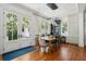 Bright dining room features a rustic wood table and French doors leading to the outdoors at 124 Mary St, Mount Pleasant, SC 29464