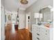 Bright entryway with hardwood floors, white dresser, and large mirror at 124 Mary St, Mount Pleasant, SC 29464