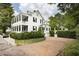 Two-story home with a charming brick driveway and lush landscaping at 124 Mary St, Mount Pleasant, SC 29464
