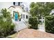 Inviting front entry with a bright teal door and white staircase at 124 Mary St, Mount Pleasant, SC 29464