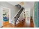 Long hallway with hardwood floors, staircase, and views into other rooms at 124 Mary St, Mount Pleasant, SC 29464