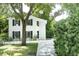 White two-story house with black shutters and a side yard at 124 Mary St, Mount Pleasant, SC 29464