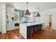 Modern kitchen with large marble island, stainless steel appliances, and hardwood floors at 124 Mary St, Mount Pleasant, SC 29464