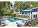 Inviting pool with blue umbrella and striped lounge chairs at 124 Mary St, Mount Pleasant, SC 29464