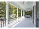 Large front porch with white columns, ceiling fan, and porch swing at 124 Mary St, Mount Pleasant, SC 29464