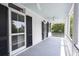 Long side porch with white columns, dark shutters, and light blue ceiling at 124 Mary St, Mount Pleasant, SC 29464