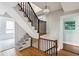 Elegant staircase with dark wood railings and patterned carpet runner at 124 Mary St, Mount Pleasant, SC 29464