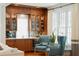 Home bar with wood cabinetry, wine cooler, and seating for two at 124 Mary St, Mount Pleasant, SC 29464