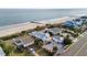 Aerial view of beach house and oceanfront community at 1306 Palmetto Blvd, Edisto Beach, SC 29438