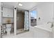 Bathroom with walk-in shower and large window at 1306 Palmetto Blvd, Edisto Beach, SC 29438