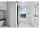 Bright bathroom with walk-in shower and window at 1306 Palmetto Blvd, Edisto Beach, SC 29438
