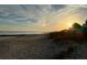 Scenic beach view at sunset, showcasing footprints in the sand at 1306 Palmetto Blvd, Edisto Beach, SC 29438