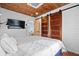 Main bedroom with king-size bed, barn door, and TV at 1306 Palmetto Blvd, Edisto Beach, SC 29438