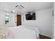 Main bedroom with large TV and flamingo bedding at 1306 Palmetto Blvd, Edisto Beach, SC 29438