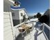 Snow-covered deck with a table and chairs, offering ocean views at 1306 Palmetto Blvd, Edisto Beach, SC 29438