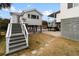 Elevated beach house with stairs and walkway at 1306 Palmetto Blvd, Edisto Beach, SC 29438