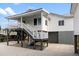 Two-story home with porch and stairs at 1306 Palmetto Blvd, Edisto Beach, SC 29438