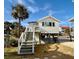 Cute beach cottage with private balcony and stairs at 1306 Palmetto Blvd, Edisto Beach, SC 29438