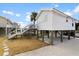 Elevated beach house with stairs, white siding and grey trim at 1306 Palmetto Blvd, Edisto Beach, SC 29438