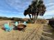 Inviting fire pit with seating for enjoying outdoor evenings at 1306 Palmetto Blvd, Edisto Beach, SC 29438